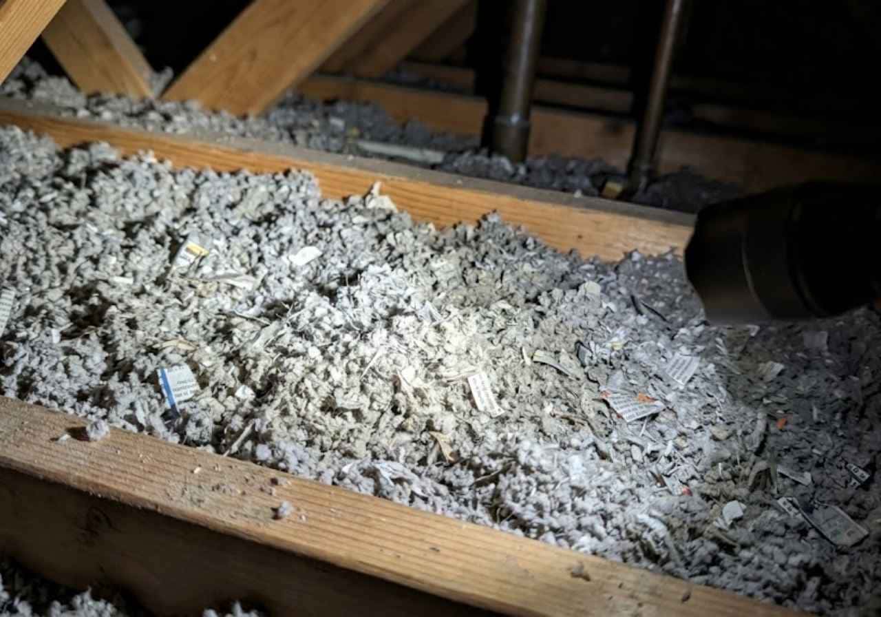 Gray cellulose insulation between attic joists