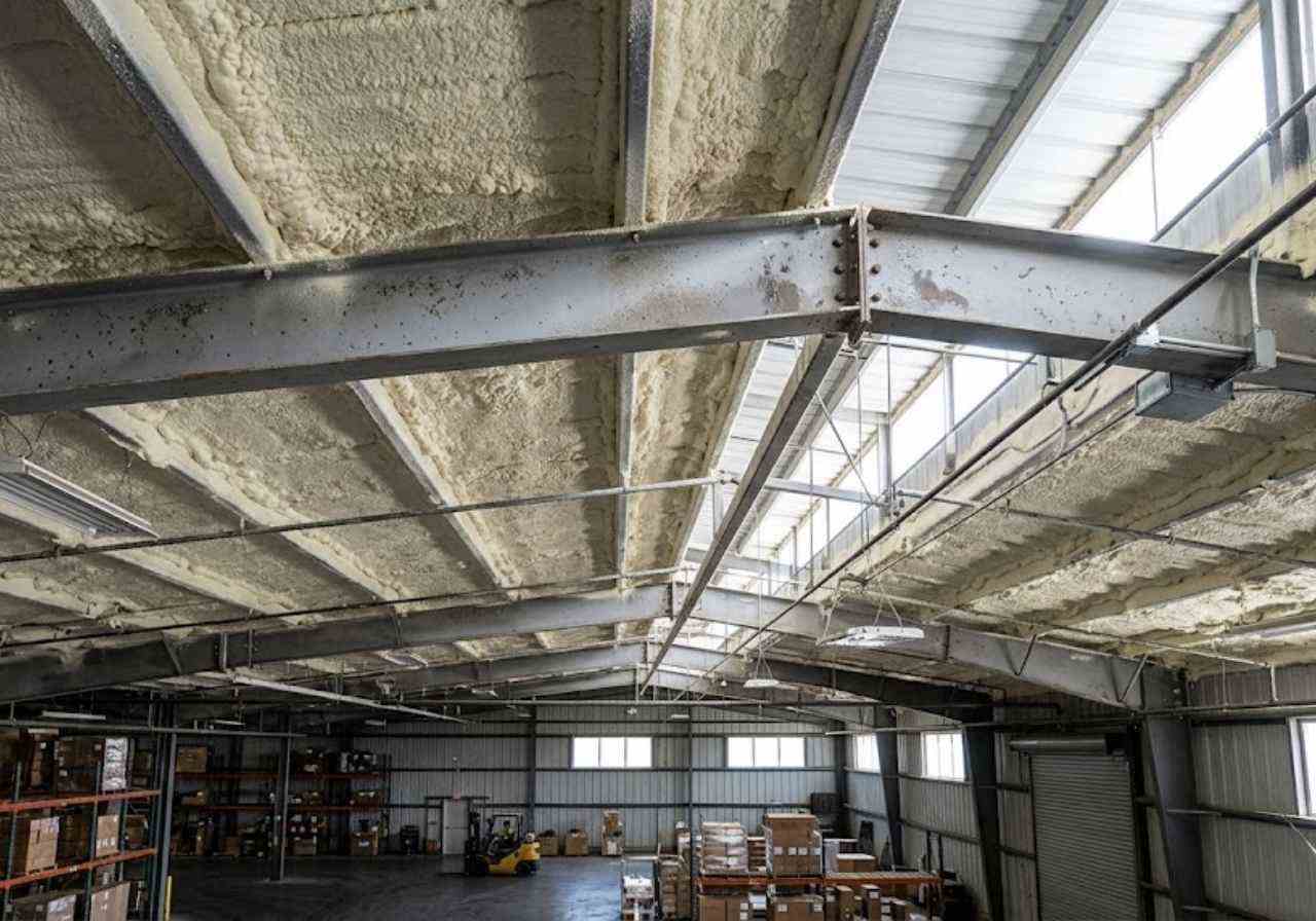 Spray foam under a Denver warehouse metal roof