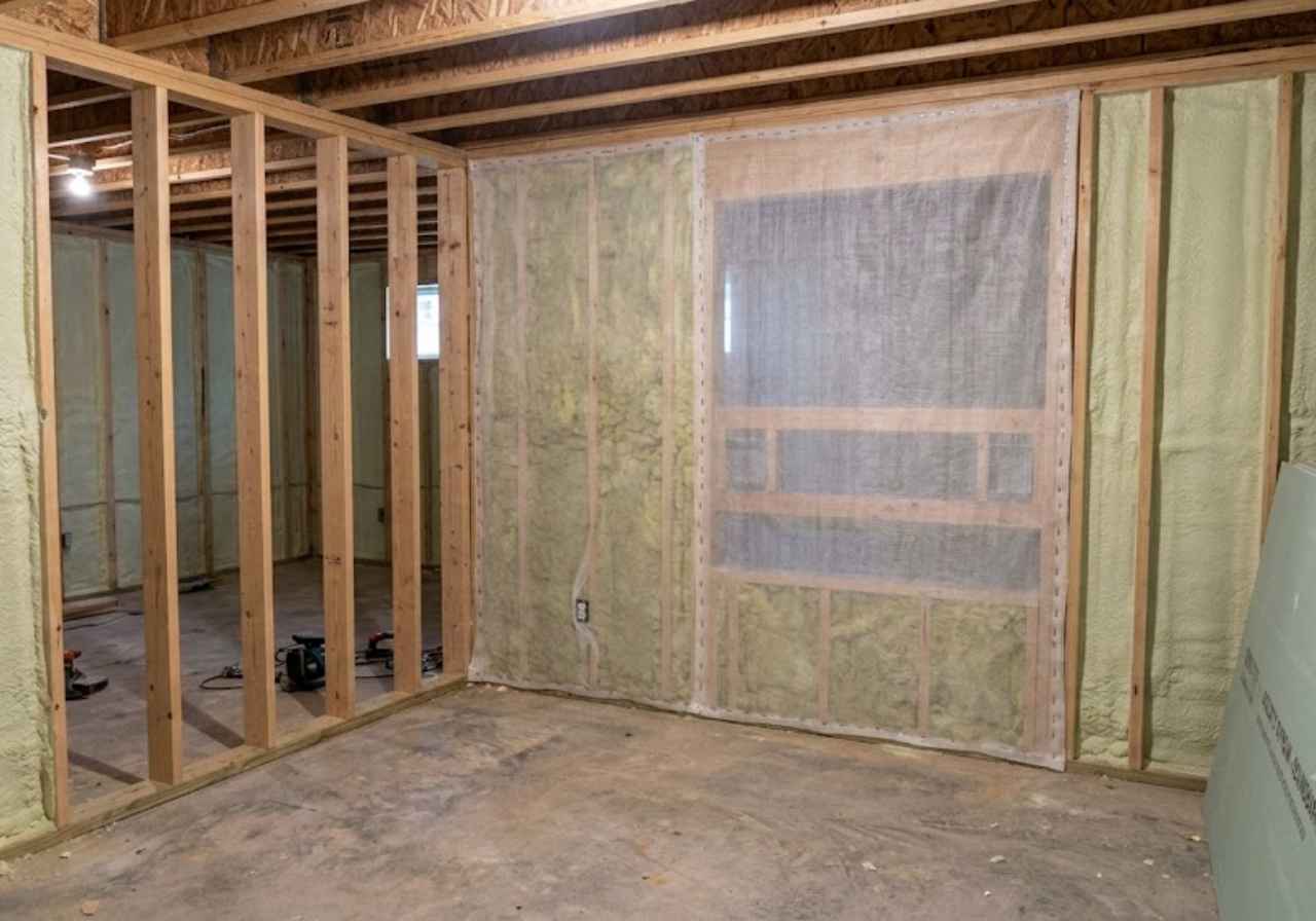 Netting holding blown fiberglass in an open stud wall