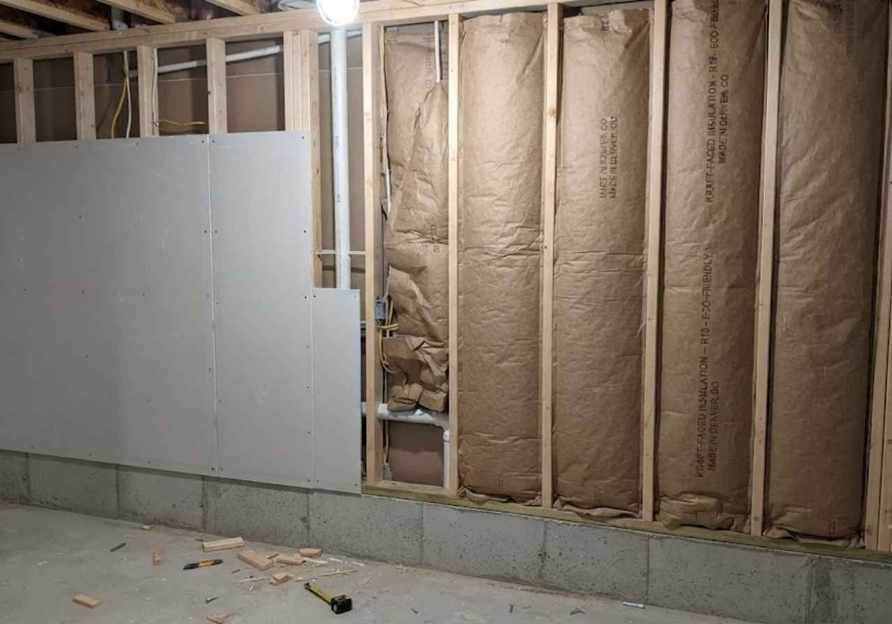 Drywall covering kraft-faced insulation in a Denver basement